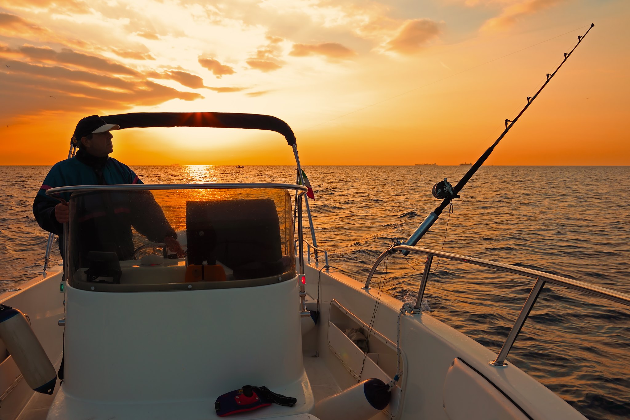 Angler on a fishing boat in the bay at Islands of Rockport
